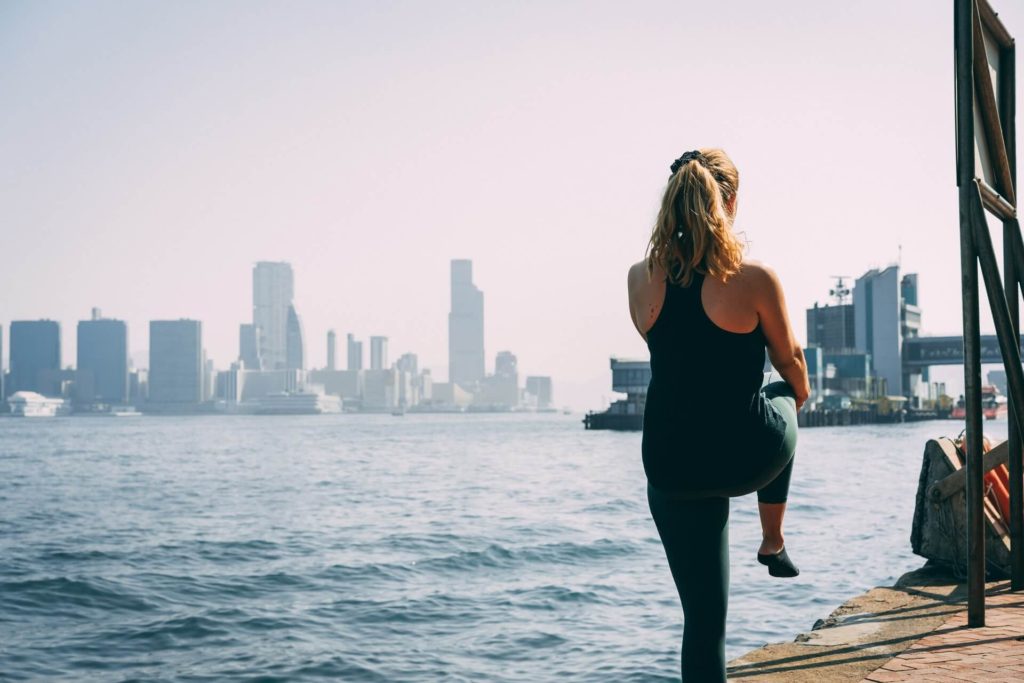 Woman stretching by the water