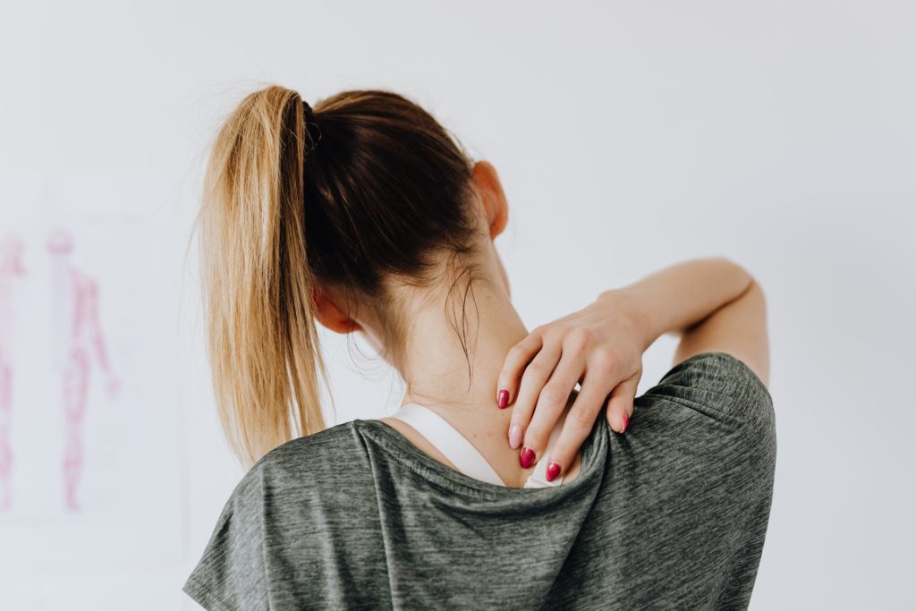 Woman experiencing neck pain