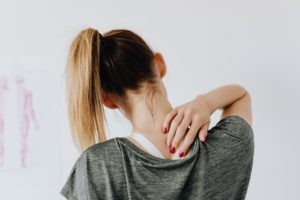 Woman experiencing neck pain